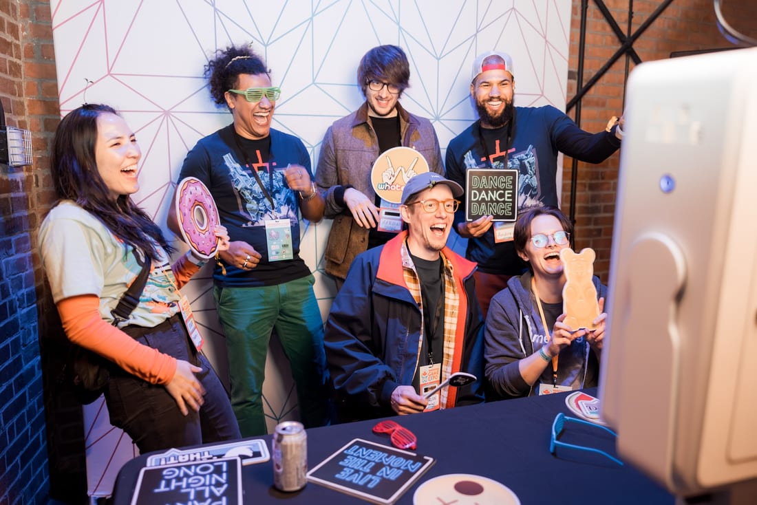 VGX staff and sponsors laughing together at the photo booth