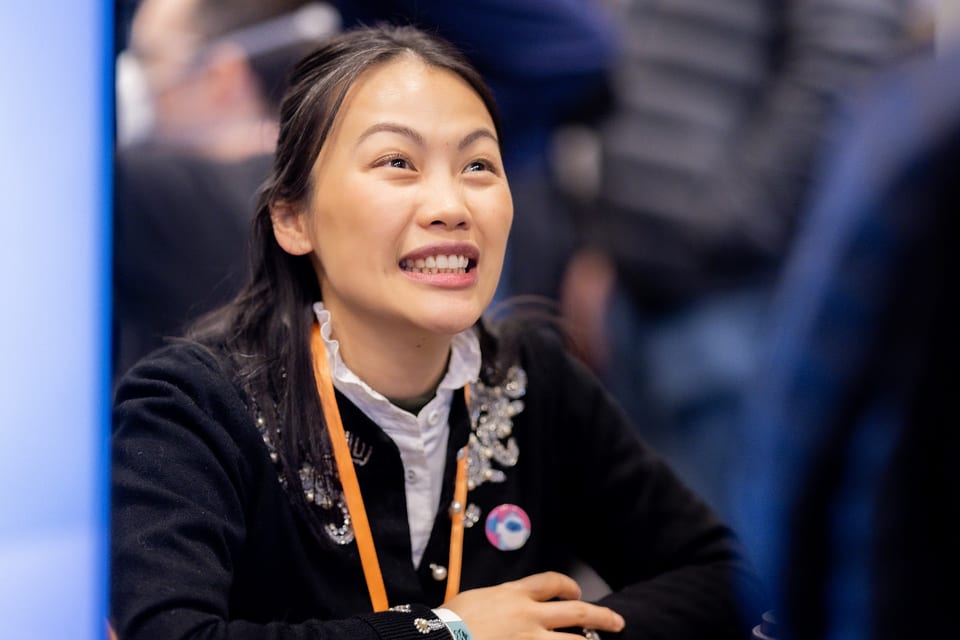 Attendee smiling during a meet and greet with a special guest
