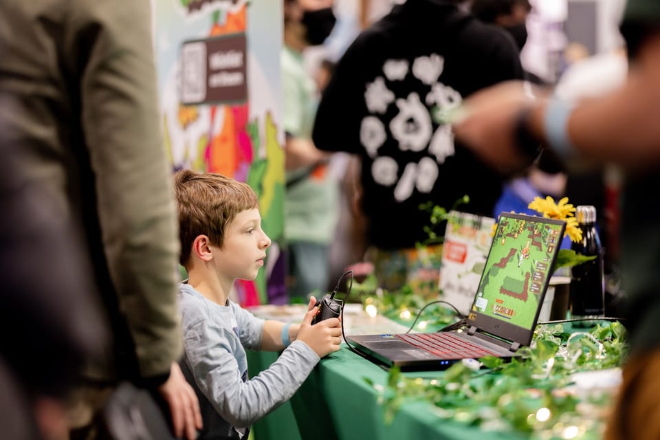 Young attendee playing an indie game at a VGX Selects station